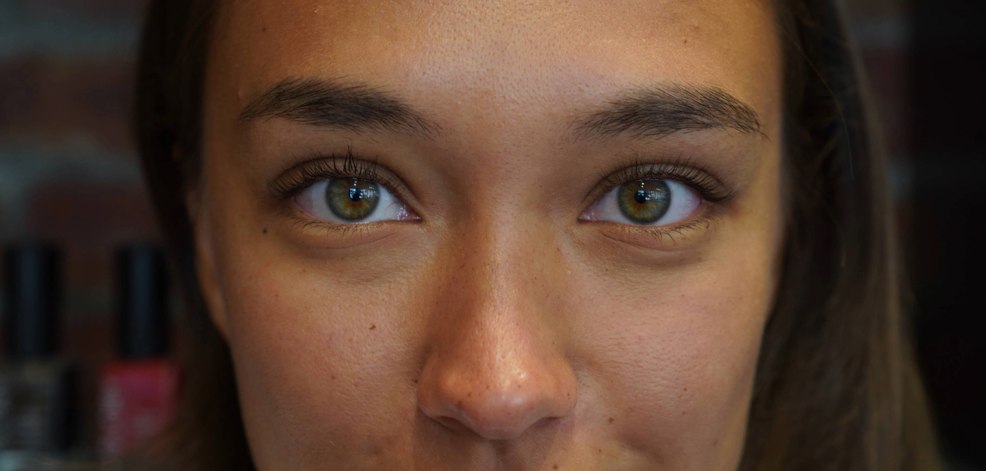 Close-up of natural lash extensions, hazel eyes